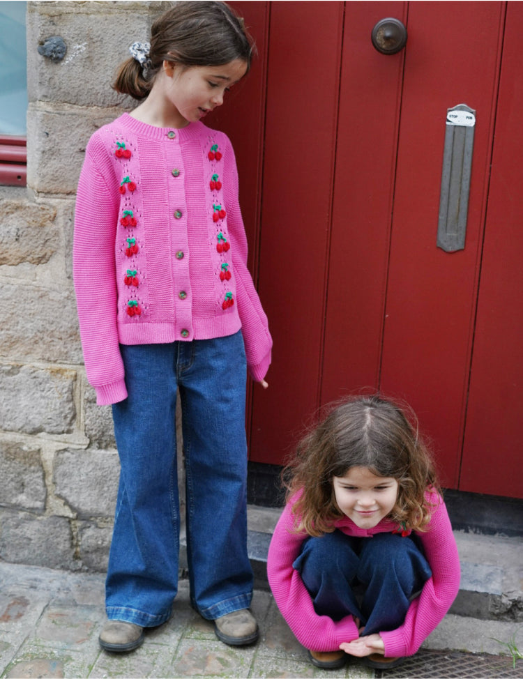 girl standing next to a girl sitting down