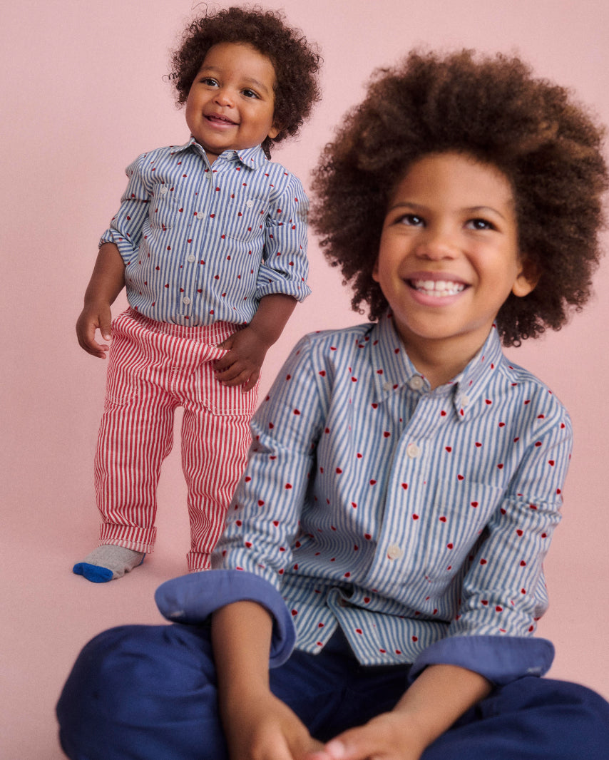 Children wearing Mini Valentines blue shirts with red heart print 