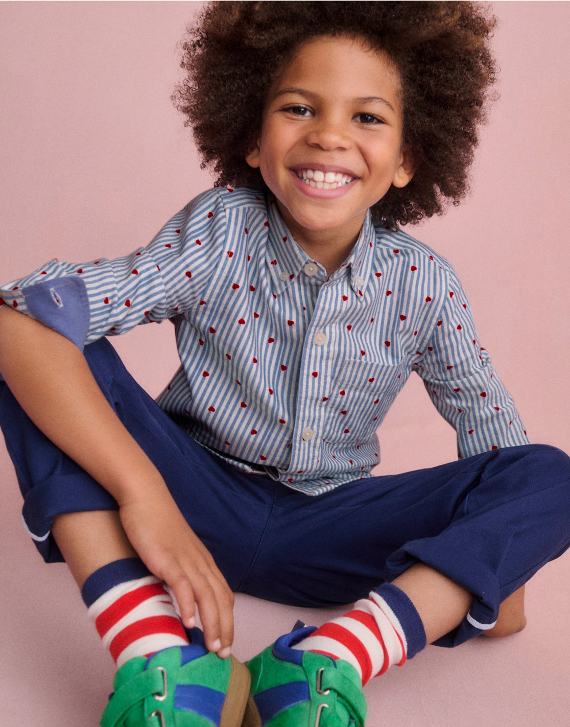 boy sitting down smiling 